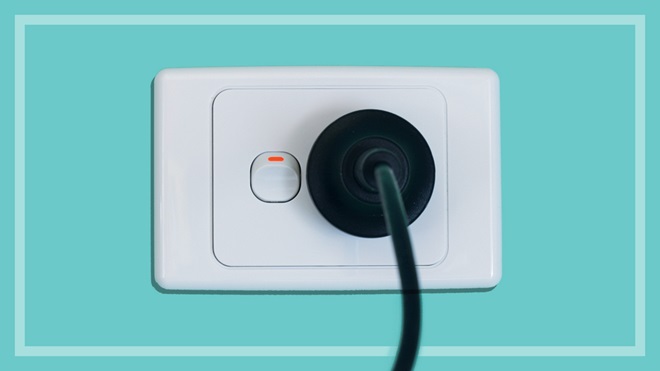 power cord connected to a switched on power point on wall
